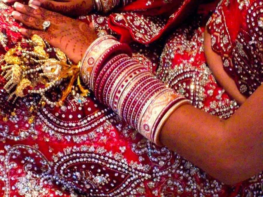A bride's hands with bangles and mehndi at an Indian wedding